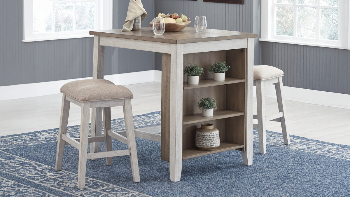 Kitchen table with shelves and stools in a room with blue carpet and white walls.