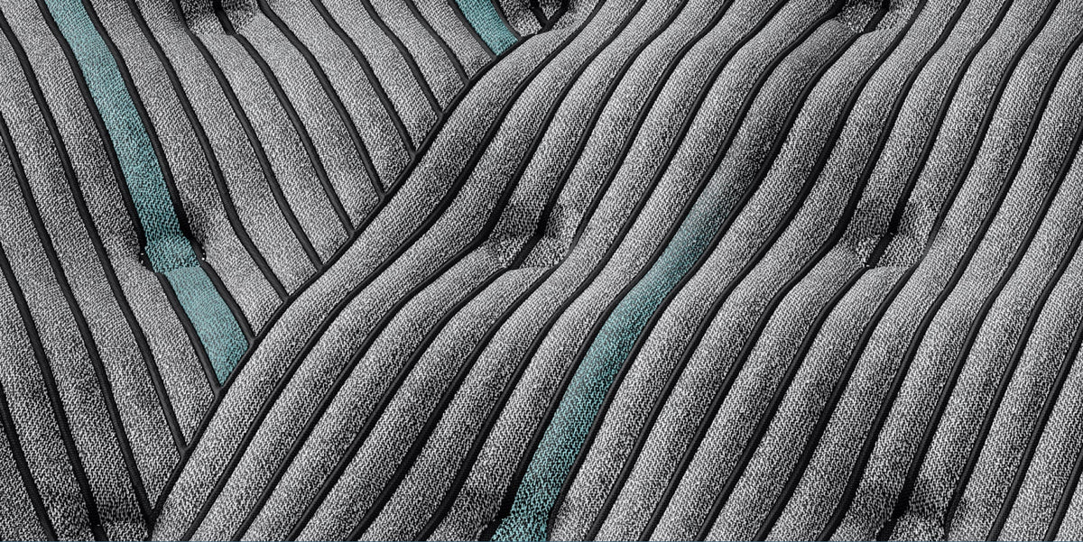 Close-up of textured fabric on mattress with wavy pattern